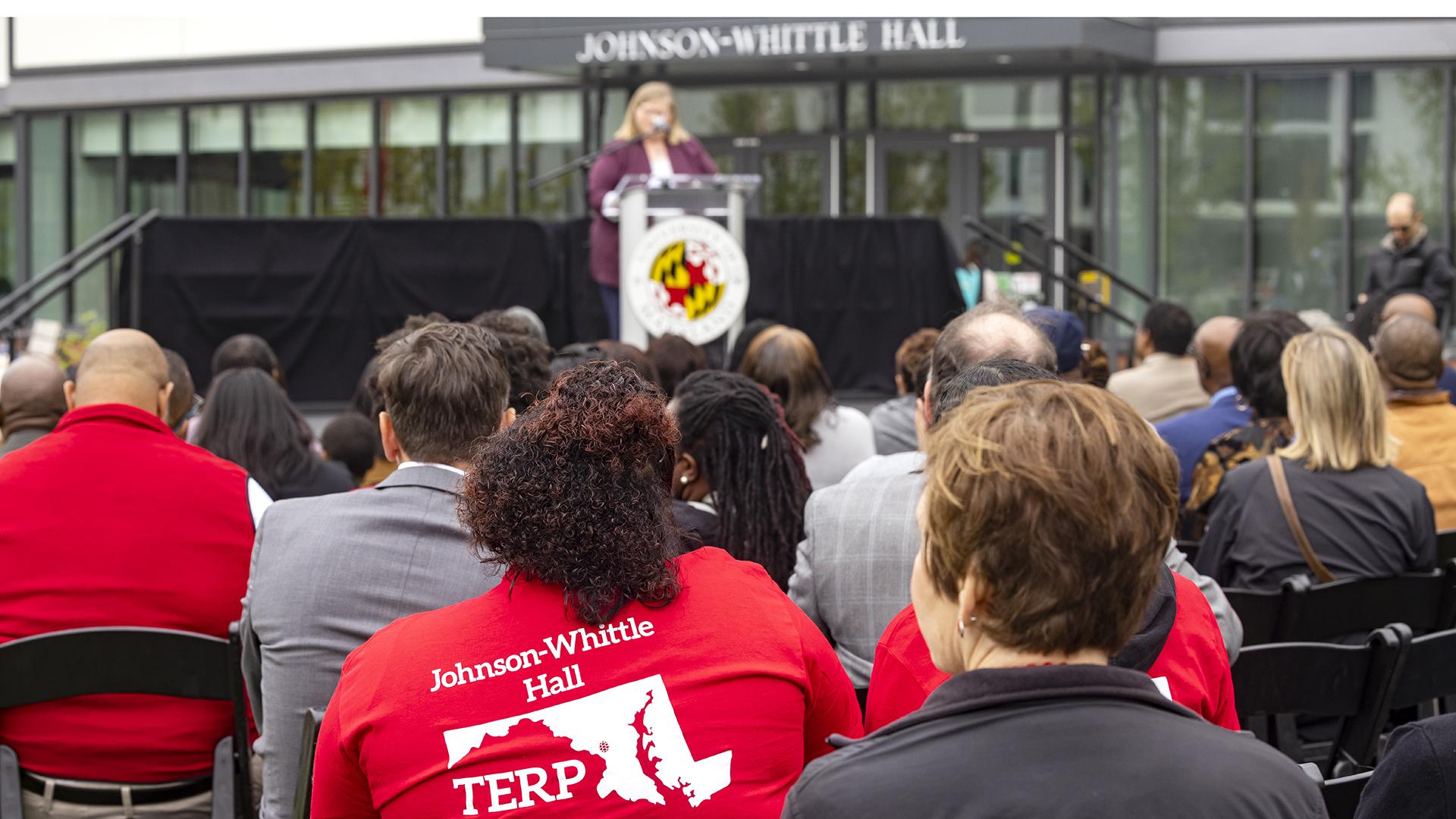 A crowd looks on as VP for Student Affairs, Dr. Patty Perillo, speaks at the dedication of Johnson-Whittle Hall