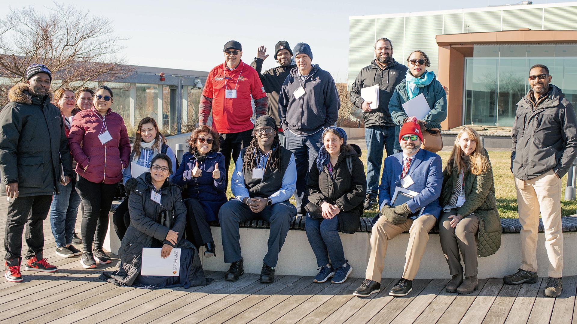 ResFac staff gather on a roof of a building to take a photo together